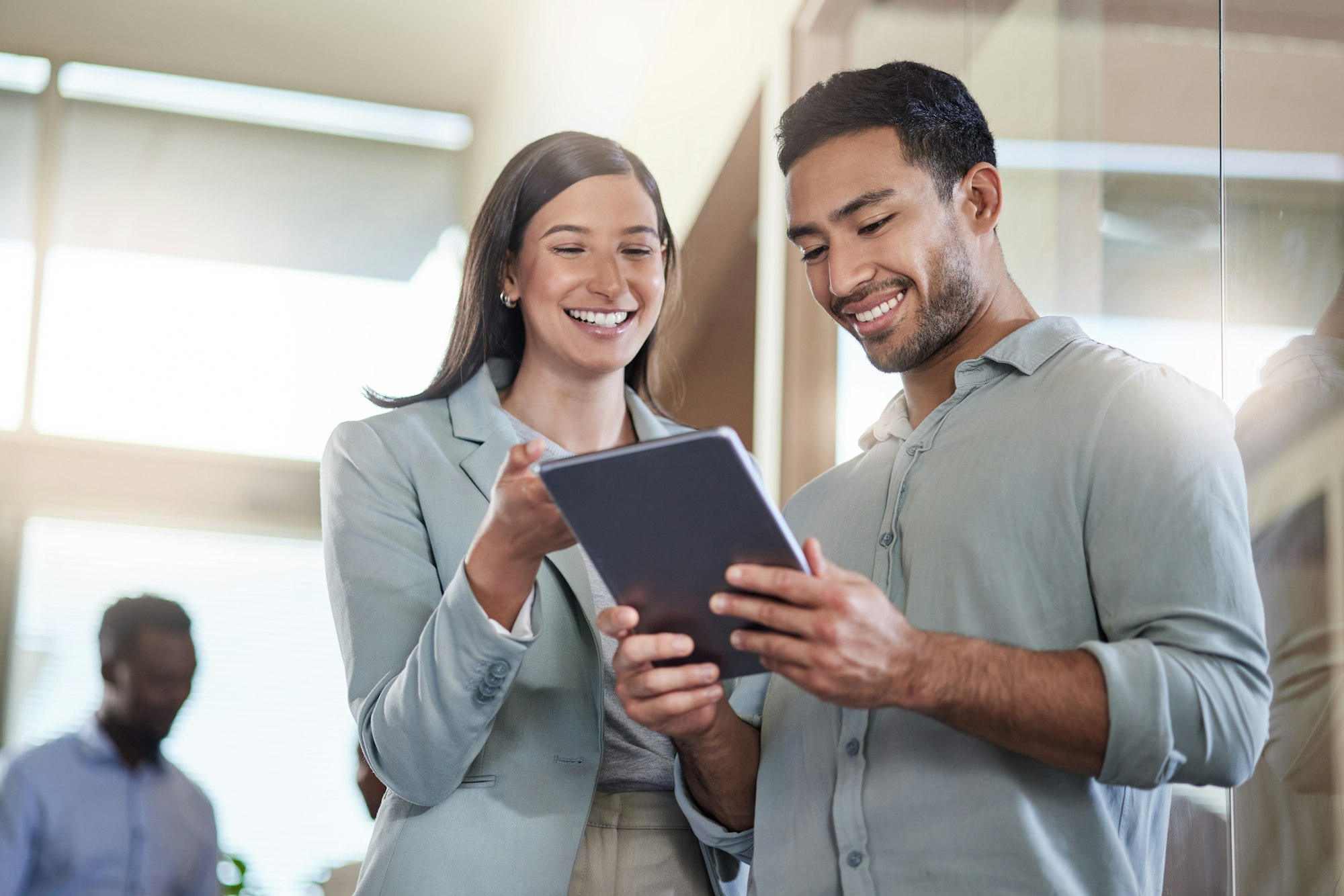 Two strategists reviewing a campaign on a tablet